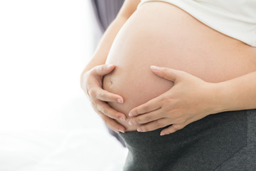 Fototapeta na wymiar Size of belly eight month pregnant women
