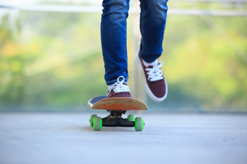 Skateboarder legs skateboarding at city