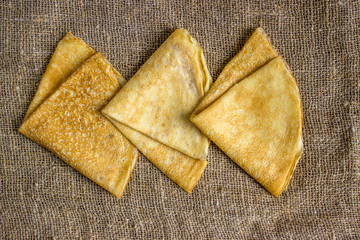 Thin Pancakes on a Sacking Background Top View. Fresh Homemade Crepes.