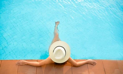 Gardinen Asia woman lifestyle relaxing near luxury swimming pool sunbath, summer day at the beach resort in the hotel. Concept Summer. © freebird7977
