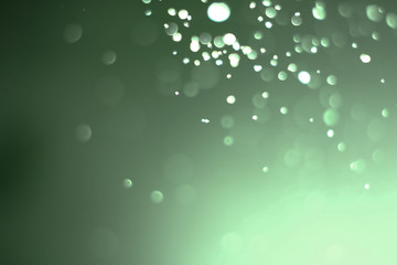 Beautiful and blurry bokeh on a green background.