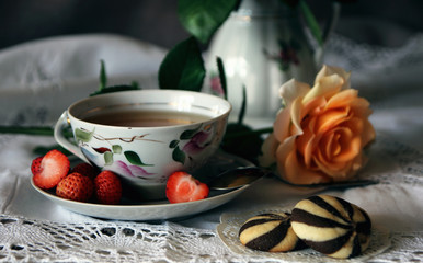 A cup of tea, a biscuit and a rose..