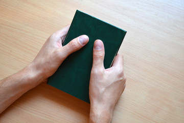 hands with a book