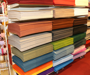 Shelf full of fabrics for sale at the fair of decoration
