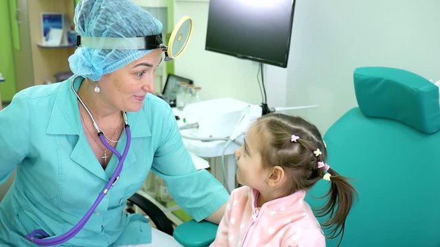 Portrait doctor otolaryngologist and child in clinic, kid smiling shows sign of approval, happy doctor's reception, children's in hospital, pediatric physician lor accepting patient