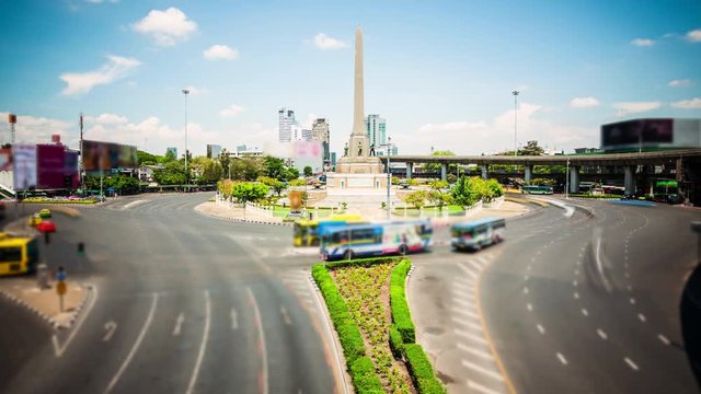 Traffic in roundabout surrounding Victory Monument in Bangkok, Thailand, timelapse (blurred logos for commercial use)