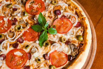 Delicious pizza with meat, cheese and mushrooms