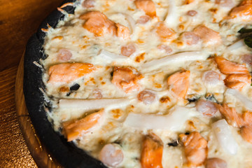 Delicious pizza with meat, cheese and mushrooms