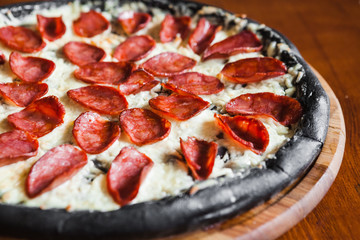 Delicious pizza with meat, cheese and mushrooms
