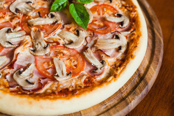 Delicious pizza with meat, cheese and mushrooms