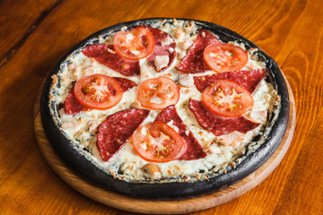 Delicious pizza with meat, cheese and mushrooms