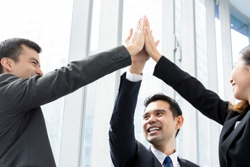 Business colleagues giving high five celebrating success