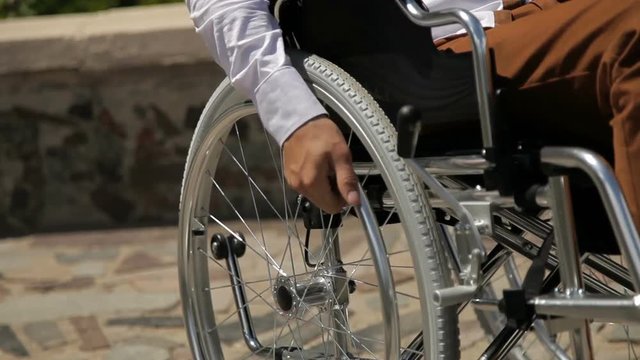 Close up of young disabled man in wheelchair