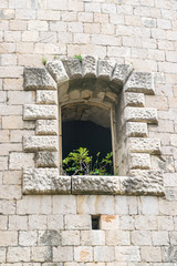 Fototapeta na wymiar Windows in the stone walls of the fortress Mamula. Montenegro, Boka-Kotor Bay.