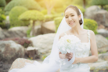 beautiful young woman on wedding day in white dress in the garden. Female portrait in the park - Selective focus.