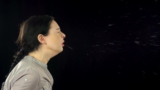 Woman sneezing in slow motion.