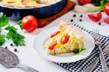 French open pie from short pastry, kish, tart with chicken, cherry tomatoes, greens and creamy cheese cress, filling, sauce and spices, pepper, lettuce and salt on white rustic background