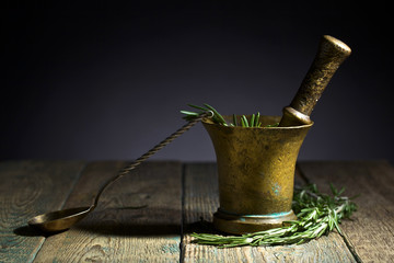 Old copper mortar with rosemary .
