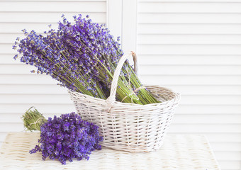 Basket with a lavender and white wooden shutters.