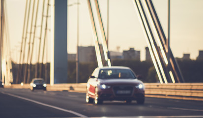 Cars driving on bridge road defocused image