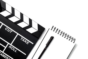 Fototapeta na wymiar Work table of producer. Movie clapperboard and notebook on white background top view copyspace