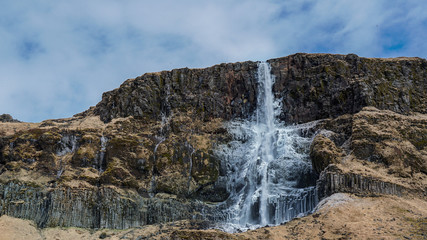 Majestic landscape, waterfall in Iceland. frozen melting after winter