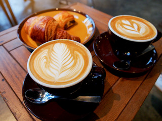 Hot coffee latte and croissant for breakfast.