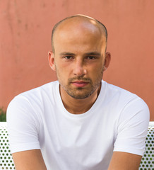 Tired bald man sitting close up