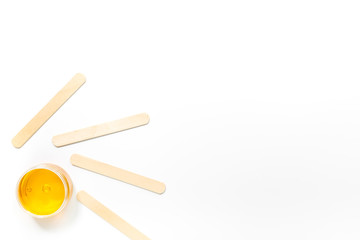 Wax and sticks for depilation on white background top view copyspace