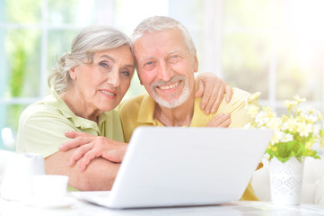 senior couple looking at laptop
