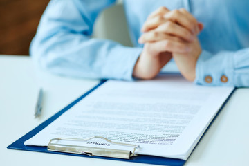 Hands of woman preparing to sign the contract document with pen on desk. selective focus image on sign a contract.