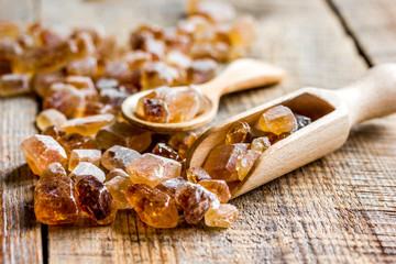 lumps of white and brown sugar on wooden table background