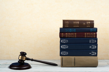 Law concept open book with wooden judges gavel on table in a courtroom or law enforcement office,...