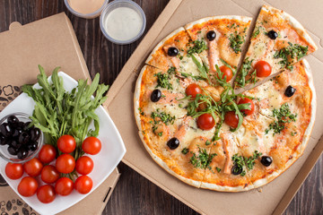 Pizza in delivery cardboard box flat lay