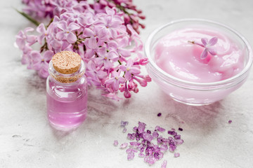 Obraz na płótnie Canvas lilac natural cosmetic set for spa with cream stone table background