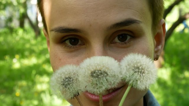 Young Girl Blowing On Dandelions. Spring Portrait, Girl With Dandelions.