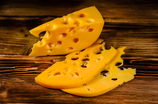 Sliced cheese on wooden table