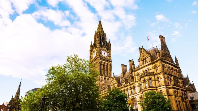 Manchester, UK. Town Hall of Manchester, UK with cloudy sky during the sunny day. Time-lapse with moving clouds and clock