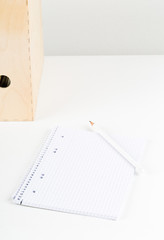 White office desk with empty notepad, pencil and folders