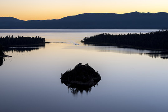 Fannette Island reflects in Emerald Bay on a perfect calm morning before sunrise in South Lake Tahoe, California.