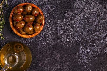 Olive oil, olives on dark background.