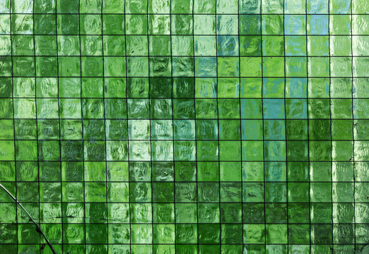 background mosaic consisting of small square glass tiles in tints of green