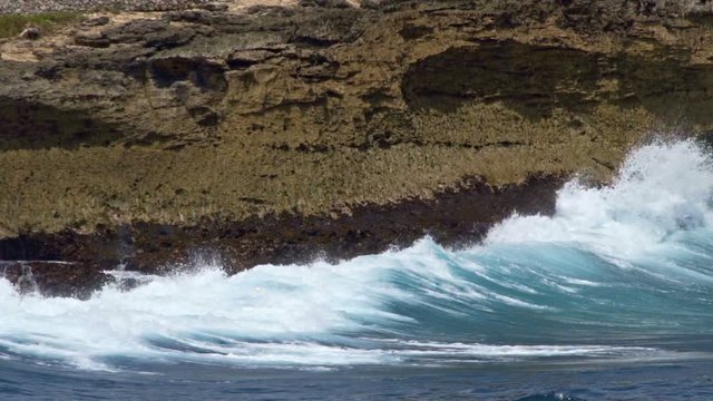 Sea waves break of the rocky shore 2 slow motion
