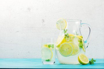 Lemonade homemade drink - jar and glass on table