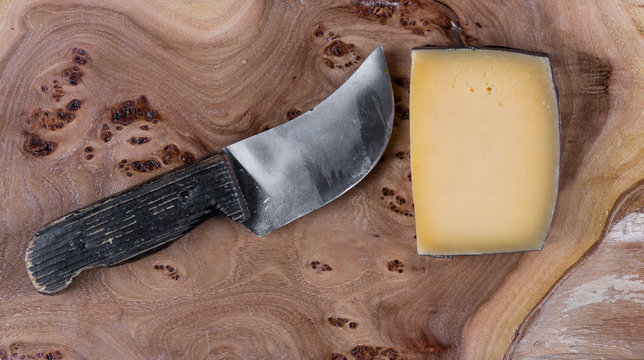 French, Italian cheese and knife on an old, rustic table