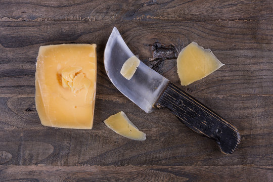French, Italian cheese and knife on an old, rustic table