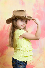 little girl in cowboy or cowgirl outfit with hat