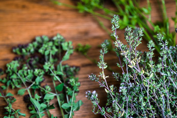 bunch of garden fresh herbs on wooden board from above