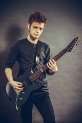 Obraz premium Young man playing electric guitar