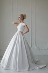 Fototapeta premium portrait of beautiful blonde bride with fashion hairstyle and make-up